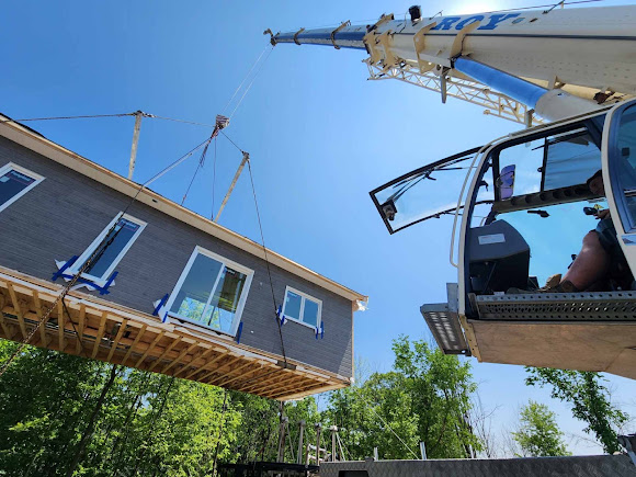 A mobile crane provides the reach and lifting capacity needed to position large building sections safely and efficiently.
